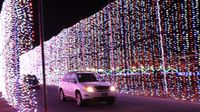 Cars make their way through more than 3 million million lights along the 3.75-mile Speedway Christmas course.