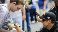 Matt Kenseth signs an autograph for a fan at the Coca-Cola 600 at Charlotte Motor Speedway.