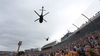 Military helicopters fly over the crowd during a rousing pre-race at the Coca-Cola 600 at Charlotte Motor Speedway.