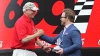 Charlotte Motor Speedway President and General Manager Marcus Smith presents USO of North Carolina's John Falkenbury with the Stonewall Jackson Award during pre-race at the Coca-Cola 600 at Charlotte Motor Speedway.