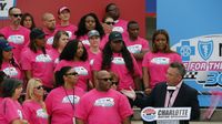 NASCAR anaylst Hermie Sadler greets a group of breast cancer survivors and their families on hand to kick off Breast Cancer Awareness Month and preview the Drive for the Cure 300 NASCAR XFINITY Series race at Charlotte Motor Speedway.