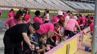 Hundreds of breast cancer survivors and supporters helped paint pit wall pink during an event to kick off Breast Cancer Awareness Month and preview the Drive for the Cure 300 NASCAR XFINITY Series race at Charlotte Motor Speedway.