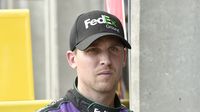 Denny Hamlin stands in the garage during practice during Bojangles' Pole Night at Charlotte Motor Speedway.