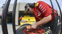 A crew member checks tire temperatures during Bojangles' Pole Night at Charlotte Motor Speedway.