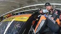 Kurt Busch climbs into his car before a practice run Friday at Charlotte Motor Speedway.