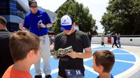 NASCAR XFINITY Series driver Ty Dillon signs autographs during the seventh annual Parade of Power at Charlotte Motor Speedway on Wednesday.