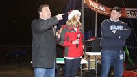 Fox46 TV personalities Kayla Ayers and Brian Basham greet runners before the Egg Nog Jog 5K during opening night of the sixth annual Speedway Christmas at Charlotte Motor Speedway.