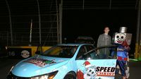 Lug Nut poses for a photo with Charlotte Hornets star Cody Zeller, who served as Honorary Pace Car Driver for opening night of the sixth annual Speedway Christmas at Charlotte Motor Speedway.