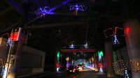 Cars drive through the concourse during opening night of the sixth annual Speedway Christmas at Charlotte Motor Speedway.