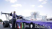 JR Todd poses for photos after unveiling the Jimi Hendrix Foundation Top Fuel dragster he will drive this weekend at the NHRA Carolina Nationals at zMAX Dragway.