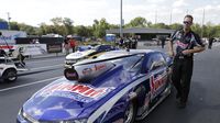 Jason Line walks beside his car in the staging lanes during opening day at the NHRA Carolina Nationals at zMAX Dragway.