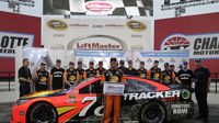 Martin Truex Jr. and team pose for a photo after earning the pole for Sunday's Coca-Cola 600 during Thursday's LiftMaster Pole Night at Charlotte Motor Speedway.