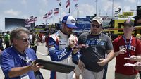 Jimmie Johnson signs autographs for fans during Thursday's LiftMaster Pole Night at Charlotte Motor Speedway.