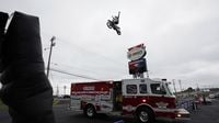 Charlotte Motor Speedway's Rosenbauer fire truck drives under a high-flying motocross display during the eighth annual Parade of Power at Charlotte Motor Speedway.