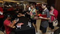 Bubba Wallace Jr. signs autographs for fans during the eighth annual Parade of Power at Charlotte Motor Speedway.