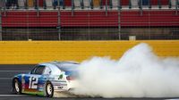 Joey Logano celebrates with a burnout during a rare Sunday Bank of America 500/Drive for the Cure 300 doubleheader at Charlotte Motor Speedway.