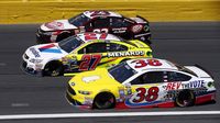 Landon Cassill, Paul Menard and David Ragan race three-wide during a rare Sunday Bank of America 500/Drive for the Cure 300 doubleheader at Charlotte Motor Speedway.