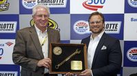 Marcus Smith presents former car owner/crew chief Travis Carter with the Smokey Yunick Award during a rare Sunday Bank of America 500/Drive for the Cure 300 doubleheader at Charlotte Motor Speedway.