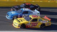 Eventual race winner Joey Logano (12) goes three-wide with Martin Roy and Mike Harmon during a rare Sunday Bank of America 500/Drive for the Cure 300 doubleheader at Charlotte Motor Speedway.