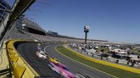Cars race through Turn 1 during a rare Sunday Bank of America 500/Drive for the Cure 300 doubleheader at Charlotte Motor Speedway.