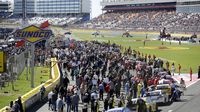 Drivers, teams and fans fill pit road during a rare Sunday Bank of America 500/Drive for the Cure 300 doubleheader at Charlotte Motor Speedway.