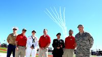 Military personnel prepare to give the command to fire engines during a rare Sunday Bank of America 500/Drive for the Cure 300 doubleheader at Charlotte Motor Speedway.