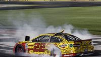 Joey Logano does a burnout to celebrate his win an action-packed NASCAR Sprint All-Star Race at Charlotte Motor Speedway.
