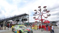 A newly added Ferris Wheel rises over Turn 4 during an action-packed NASCAR Sprint All-Star Race at Charlotte Motor Speedway.