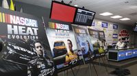 Dusenberry Martin Racing unveils mock covers of its new NASCAR video game (coming later this year) during a rain-shortened Friday at Charlotte Motor Speedway.
