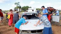Fans sign a car in the graffiti zone in the pits during the Circle K Back-to-School Monster Truck Bash at The Dirt Track at Charlotte.