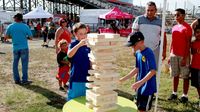 Young fans face off in a game of oversized Jenga setup during the pit party before the Circle K Back-to-School Monster Truck Bash at The Dirt Track at Charlotte.