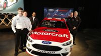 Wood Brothers Racing and Ford Performance members pose with the new No. 21 Ford Fusion NASCAR Sprint Cup Series car at the Ford Technical Support Center during Ford Wednesday programs at the Charlotte Motor Speedway Media Tour presented by Technocom.
