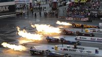 Four-wide jet car racing lights up the start line during Saturday's qualifying action at the NHRA 4-Wide Nationals presented by Lowes Foods.