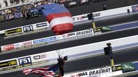 A member of the Team FastTrax jump team parachutes in during elimination Sunday at the NHRA 4-Wide Nationals presented by Lowes Foods.