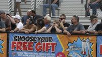 Fans stand along the fence naer the start line to get a close up view of the action during Friday's qualifying action at the NHRA 4-Wide Nationals presented by Lowes Foods.