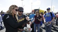 Top Fuel driver Leah Pritchett signs autographs for fans during Saturday's qualifying action at the NHRA 4-Wide Nationals presented by Lowes Foods.