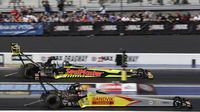 Top Fuel drivers Shawn Langdon and JR Todd race off the start line during Saturday's qualifying action at the NHRA Carolina Nationals at zMAX Dragway.