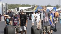 Fans take home some well-used souvenirs during opening-day qualifying at the NHRA Carolina Nationals at zMAX Dragway.