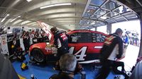 Clint Bowyer's crew works in the garage before Cup practice during Saturday's Hisense 4K TV 300 at Charlotte Motor Speedway.