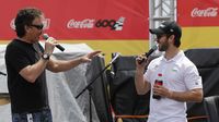 Country radio personality Paul Schadt and Cup Series driver Daniel Suarez chat during the pre-race pit party before Sunday's running of the Coca-Cola 600 at Charlotte Motor Speedway.