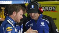 Dale Earnhardt Jr. compares notes in the garage after Cup practice during Saturday's Hisense 4K TV 300 at Charlotte Motor Speedway.