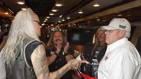 NASCAR team owner Rick Hendrick swaps stories with members of the Hall of Fame rock group Lynyrd Skynyrd before Sunday's running of the Coca-Cola 600 at Charlotte Motor Speedway.