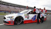 Kevin Harvick's crew pushes his car down pit road during Thursday's LiftMaster Pole Night at Charlotte Motor Speedway. 