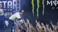 Brad Keselowski high fives fans at driver introductions during Monster Energy All-Star Saturday at Charlotte Motor Speedway.