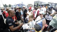 Antron Brown signs autographs for fans in the pits during an action-packed Saturday at the NHRA Carolina Nationals.