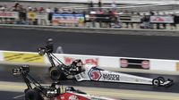 Top Fuel drivers Antron Brown (top) and Doug Kalitta power down the track during qualifying during an action-packed Saturday at the NHRA Carolina Nationals.