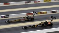Don Schumacher Racing teammates Leah Pritchett (top) and Tony Schumacher make side-by-side qualifying passes during the during the opening day of the NHRA Carolina Nationals at zMAX Dragway.