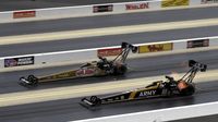 Don Schumacher Racing teammates Leah Pritchett (top) and Tony Schumacher make side-by-side qualifying passes during the during the opening day of the NHRA Carolina Nationals at zMAX Dragway.