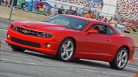 A bright red Camaro rips through the AutoCross course on All-American Sunday at the 22nd annual Goodguys Southeastern Nationals at Charlotte Motor Speedway.