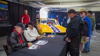 NHRA legends Bruce Larson and Don "The Snake" Prudhomme sign autographs for fans during Friday's action at the Pennzoil AutoFair at Charlotte Motor Speedway.